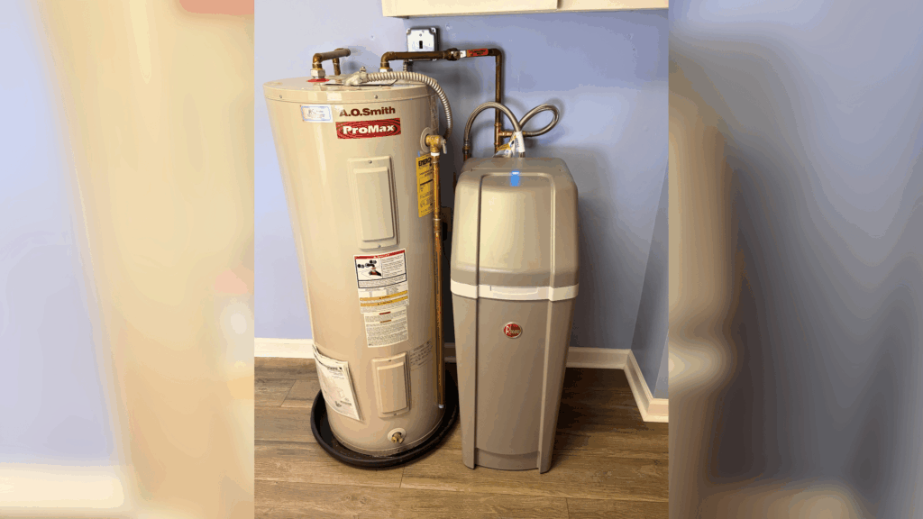 A.O. Smith ProMax water heater tank connected to a water softener system in a basement utility room